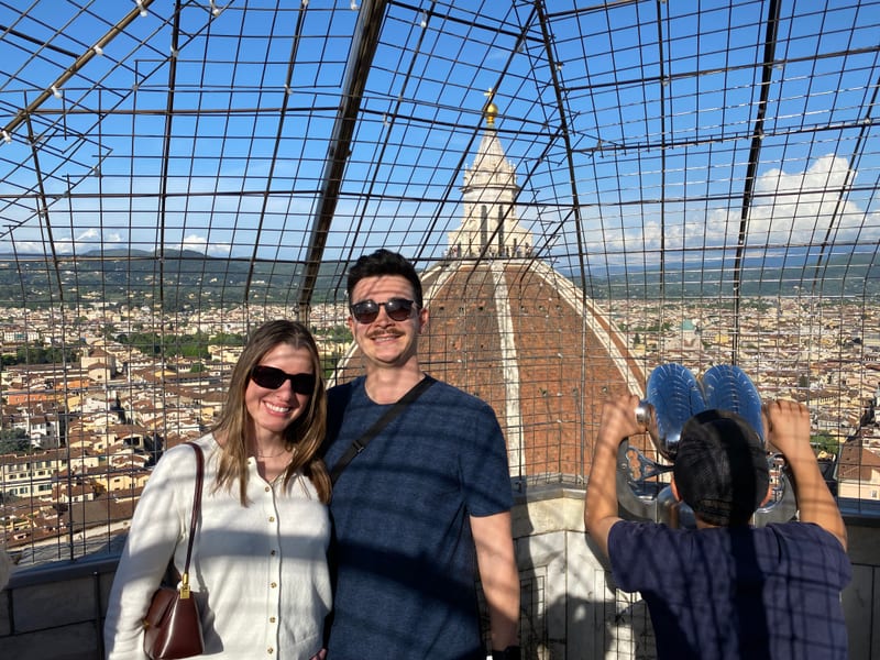 Scott and his partner at the top of the Duomo in Florence, the city behind them