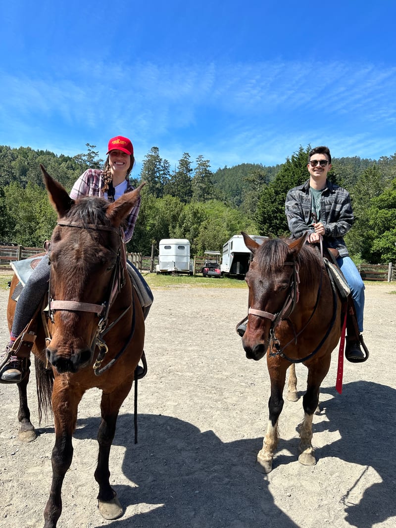 Scott and his partner on horseback at a trail ranch